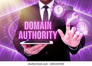 Text sign showing Domain Authority. Business idea calculated metric for how well a domain is likely to rank Man In Office Uniform Standing Pressing Virtual Button Holding Tablet. - Shutterstock ID 2045219435