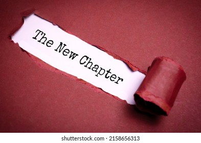 Text sign showing the NEW CHAPTER on torn paper
