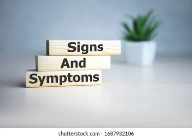 text Signs and SYMPTOMS on wooden cubes, medical concept. - Shutterstock ID 1687932106
