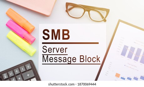 The Text SMB (Server Message Block) On Office Desk With Calculator, Markers, Glasses And Financial Charts.