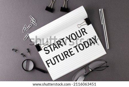 Text START YOUR FUTURE TODAY on Notebook and office tools on gray desktop