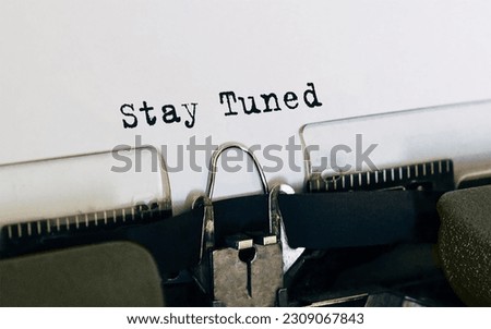 Text Stay Tuned typed on retro typewriter