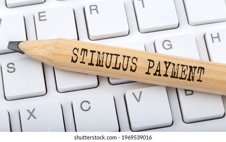 Text STIMULUS PAYMENT On Wooden Pencil On White Keyboard. Business