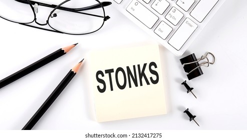 Text STONKS On Sticker With Keyboard , Pencils And Office Tools