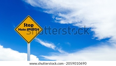 The text "Stop hate speech" on blue cloudy background