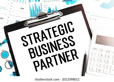 Text Strategic Business Partner On Clipboard, Pen, Calculator, Charts. Business Concept. Flat Lay.