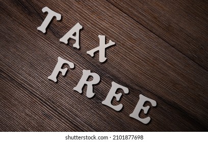 Text tax on wooden background. Financial concept.