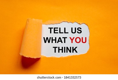 The Text 'tell Us What You Think' Appearing Behind Torn Orange Paper. Business Concept. Copy Space.