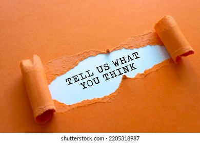 The Text 'tell Us What You Think' Appearing Behind Torn Brown Paper. Beautiful Background. Business Concept.