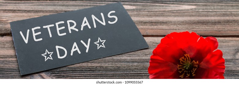 The Text Thank You Veterans Written In A Chalkboard And Red Poppy On A Rustic Wooden Background