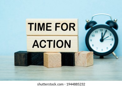 Text TIME FOR Action writing in cubes. the alarm clock, Blue background . Business concept