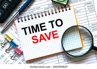 Text Time To Save on notepad with calculator, clips, pen on financial report. Financial and business concept photo