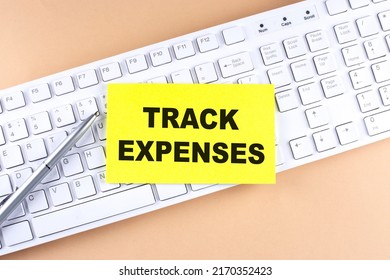 Text TRACK EXPENSES Text On Sticky On Keyboard, Business Concept