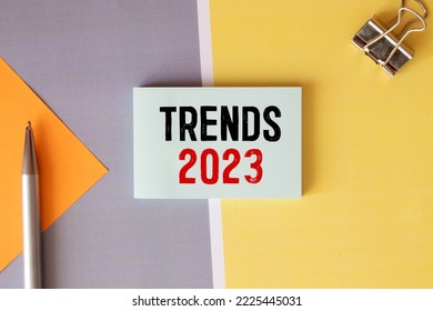 Text TRENDS 2023 on white paper between white and brown spiral notepads. - Shutterstock ID 2225445031