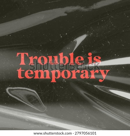 Text 'Trouble is temporary' in bold red on a dark, abstract background, conveying a message of resilience and hope.