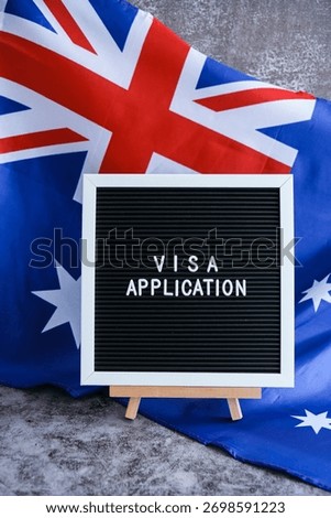 Text VISA APPLICATION on background of waving Australian flag made from silk. Concept of tourism and traveling. Inviting greeting card, advertisement