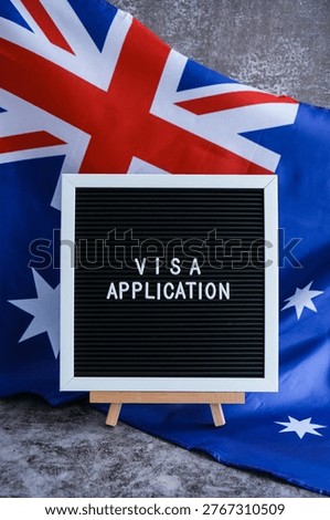 Text VISA APPLICATION on background of waving Australian flag made from silk. Concept of tourism and traveling. Inviting greeting card, advertisement