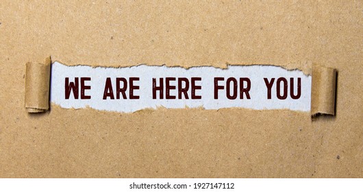 The text 'we are here for you' appearing behind torn orange paper. Business concept. Copy space. - Shutterstock ID 1927147112