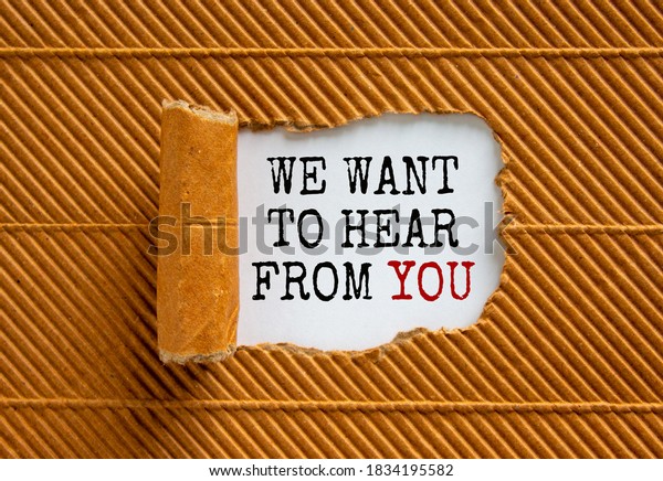 The text \'we want\
to hear from you\' appearing behind torn brown paper. Beautiful\
background. Business\
concept.