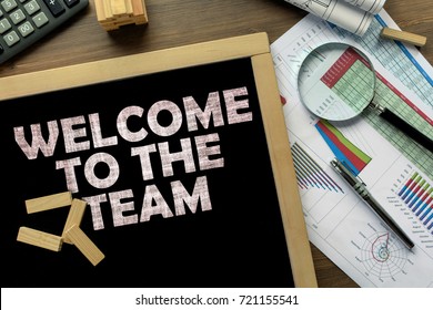 Text Welcome to the team on the blackboard on the desk with office business accessories