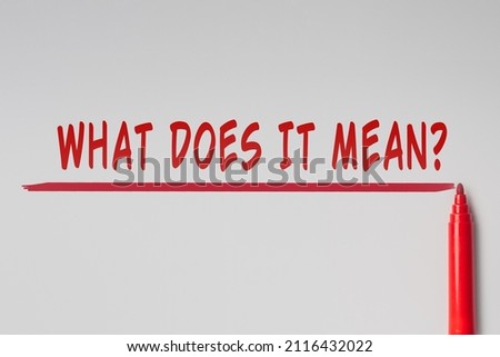 The text - What does it mean, written with red marker over red line on gray background. Concept
