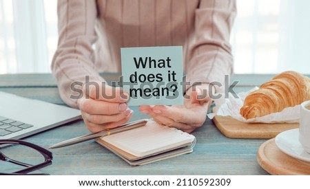 Text What Does It Means question. Concept meaning asking someone about meaning you do not understand woman holds empty paper
