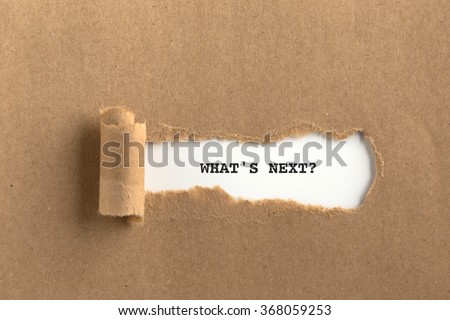 The text WHAT'S NEXT? behind torn brown paper