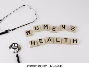 Text: WOMENS HEALTH From Wooden Letters On White Office Desk