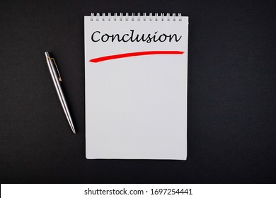 The Text, The Word Conclusion, Is Written In A Notebook Lying On A Black Table With A Pen. Business Concept