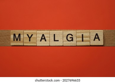 Text The Word Myalgia From Gray Wooden Small Letters With Black Font On An Red Table