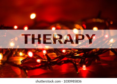 Text with the word Therapy as concept on lights background with bokeh effect. Conceptual.