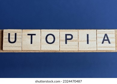 text the word utopia from brown wooden small letters on a black table
