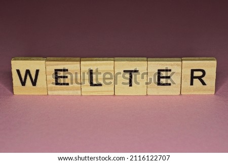 text the word welter from gray wooden small letters on an pink table