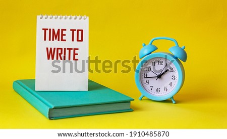 Text for writing words Time to write, text is written on notepad and yellow background. Nearby alarm clock and green notepad. Business concept for urgent traffic.