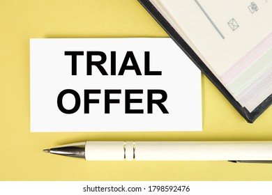 Text For Writing Words TRIAL OFFER. Business Concept Or Product Service Offered Free Of Charge To Try To Give Feedback, ON YELLOW BACKGROUND ON WHITE PAPER