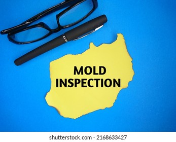 Text Written Mold Inspection At Yellow Torn, Glasses And Pen On Blue Background 