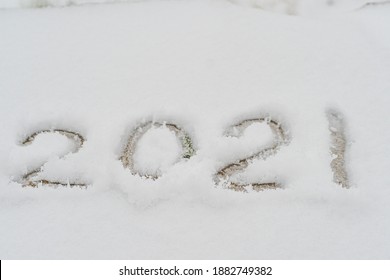 Text written in the snow, 2021. Cadaveric plan. Happy New Year greetings concept - Shutterstock ID 1882749382