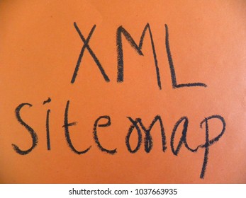 Text XML Sitemap Hand Written By Black Oil Pastel On Orange Color Paper