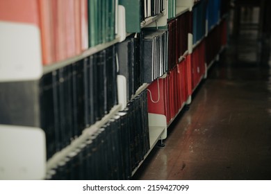 Textbook On Bookshelf In University College Library Interior