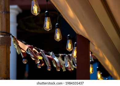 Textile Awning In The Backyard Gazebo With A Garland Of Strings Of Retro Edison Lamps Lighting Glowing With Warm Light Closeup, Nobody.