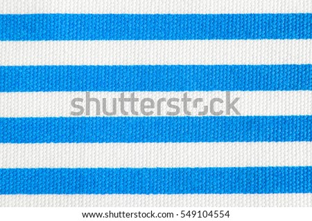 Textile background with light blue and white stripes. Fabric texture