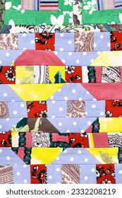 textile background - texture of handcrafted patchwork quilt close-up