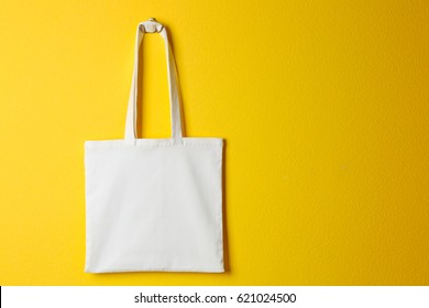 Textile bag on yellow background
