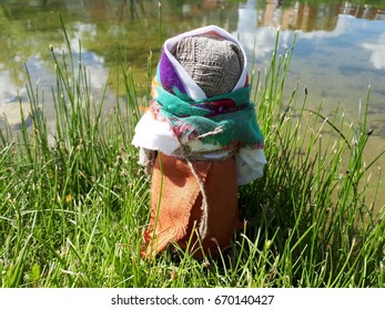 Textile doll in the grass