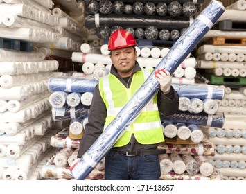 Textile factory worker carrying raw material fabric  - Powered by Shutterstock