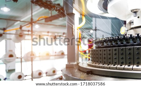 Textile industry - yarn spools on spinning machine in textile factory.