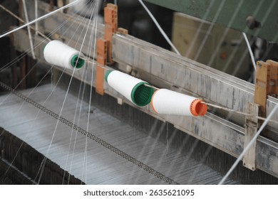Textile manufacturing process with thread spools in workshop - Powered by Shutterstock - Get 15% off with code: PIKWIZARD15
