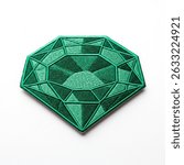 Textile patch with emerald gemstone on white background