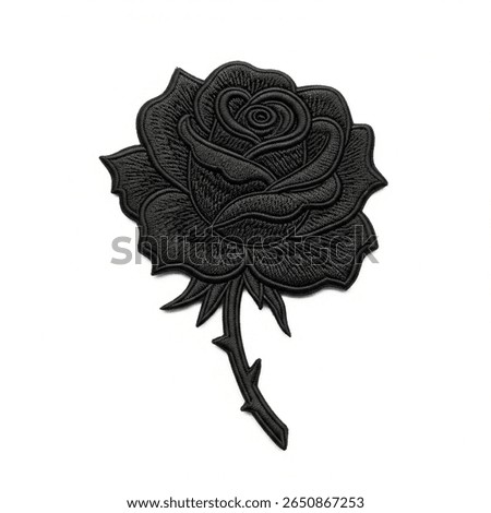 textile patch in the form of a black rose on a white background