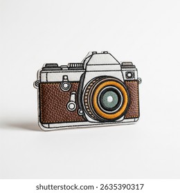 textile patch in the form of a camera on a white background